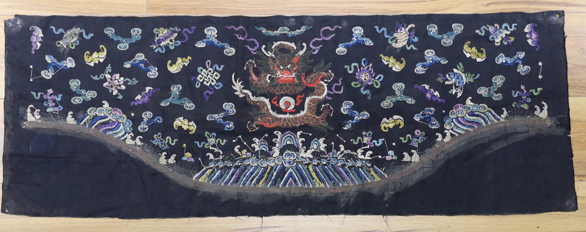 A Chinese late 19th century embroidery of a dragon, probably from a Chinese robe or hanging 37x105cm